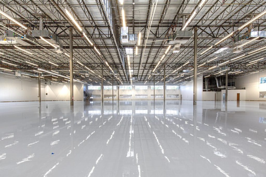 Macro-perspective of a high-performance ESD epoxy floor finish in a Houston, Texas industrial facility. This detail shot highlights the reflective, non-porous surface requirements for advanced manufacturing and cleanroom environments within the mission-critical sector. For technical specifications and case studies on this installation, visit: https://craftsmanconcretefloors.com/esd-flooring/
